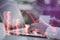 Close up of male hands using laptop with creative forex chart hologram with declining stacked coins on blurry outdoor background.