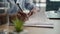 Close up male hands writing exam in class business paperwork with glass of water on office desk unrecognizable man