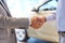 Close up of male handshake in auto show or salon