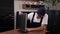 Close-up of a male handyman in overalls repairs a computer monitor.