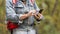 Close up male hiker hands using mobile phone.