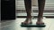 Close-up male legs foots standing on electronic scales weight control. Sporty unrecognizable guy man athlete barefoot