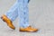 Close-up of Male Legs In Leather Brown Oxford Semi Brogues Shoes. Photographed in Motion While Walking Straight