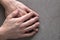 Close-up of male masculine young worker hands with rough skin and short fingernails resting on flat copy space background, top