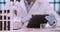 Close up of male medical scientist in laboratory typing on touchscreen device