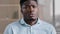 Close up male portrait of confused shocked african american millennial 30s man young adult guy worker feel displeasure