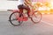 Close up male ride a bicycle red classic vintage in former beautiful with sunset light tone