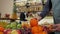 Close-up of a male salesman holding a fresh orange, a health food store.