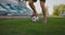 Close up of a male soccer player running with a soccer ball on the football field in the stadium demonstrating excellent