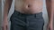 Close-up, male stomach, overweight. Young man with a naked fat belly shakes fat folds on his stomach, obesity, health