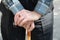 Close up of male wrinkled hands on the cane