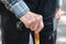 Close up of male wrinkled hands on the cane