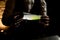 Close-up. Man bartender holds in his hands illuminated designer glass flask with smoky green liquid inside