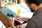 Close up of man with beer and notebook at pub