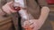 Close up of a man in beige suit pouring rose wine into a transparent glass. Action. Male sommelier pouring fruit wine at