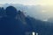 Close-up of a man with binoculars watching beautiful Alpine landscape