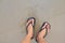 Close up of man in Black slippers feet standing at the beach