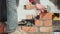 Close up of a man building a brick house. Laying red bricks on a construction site on a sunny day. House construction