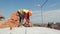 Close up of a man building a brick house. Laying red bricks on a construction site on a sunny day. House construction