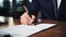 Close-up of a man in a business suit signing important documents, Ai Generated