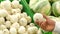 Close-up of a man chooses white onions in a supermarket. Slow motion.