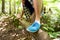 Close up of man climbing over tree trunk in woods