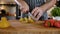 Close-up Man Cook Cuts Fresh Fruits Lemon and Strawberry on Wooden Cutting Board