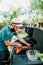 Close up of man cooking on grill,  having beers and cooking on garden barbecue. Lifestyle, leisure concept