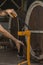 close-up of a man corking a bottle of wine at a winery .