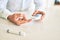 Close up of man with diabetes using insuline glucometer with blood from the finger