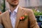 Close-up man dressed in classy jaket with three roses in poket