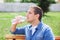 Close up of a man drinking water from a bottle outdoor. Man refreshing himself. Thirsty man drinking water from a plastic bottle i