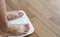 Close up a man feet on body scale checking body weight, dieting and lose weight concept