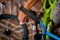 Close up of man fixing the handlebar of the bicycle, in a workshop