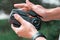 Close up of man folding drone quadcopter joystick controller at park