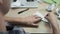 Close-up of man folding origami paper. Stock footage. Men`s hands are folded from white paper origami or airplane