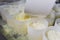 Close-up of a man forming cheese into the plastic molds at the small producing farm.