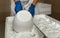 Close-up Of A Man Forming Cheese Into The White Plastic Molds At