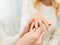 Close up of man giving diamond ring to woman