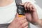 Close-up man hand fastens strap of overalls on shoulder , an element of construction workwear