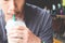 Close up of man hand holding a cup of iced coffee