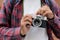 Close up of man hand holding vintage film camera, Tourist, traveller taking photo by vintage camera on vacation