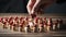 Close-up of a man hand playing chess with wooden figures