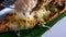 Close-Up of Man Hand Taking by Fork Grilled Lobster Meal with Herbs