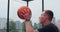 Close up man handling a ball, throwing and scoring on basketball court. Healthy lifestyle and sport concept.