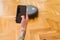 Close up of man hands controling automatic vacuum cleaner using electronic control of the mopping robot