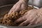 Close up of man hands, kneading raw meatballs in kneading tray. authentic anatolian food, `cigkofte`