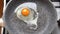 Close-up man hands a knife to break the egg over the frying pan. Top view. Cooking eggs in a small frying pan over an