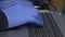 Close-up of man hands in latex gloves typing on laptop keyboard computer Coronavirus COVID-19 prevention c
