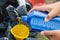 Close up on man hands. Mechanic pouring new engine oil to motorcycle engine